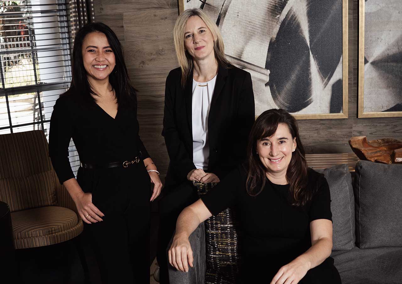 A photo of the three named plaintiffs in Widakuswara v. Lake, the two VOA journalists and one USAGM strategist.