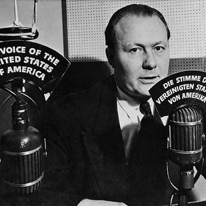 Archive photo of VOA journalist Robert Bauer at a microphone in 1942.