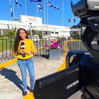 Photo of a VOA journalist reporting from outside of a hospital.